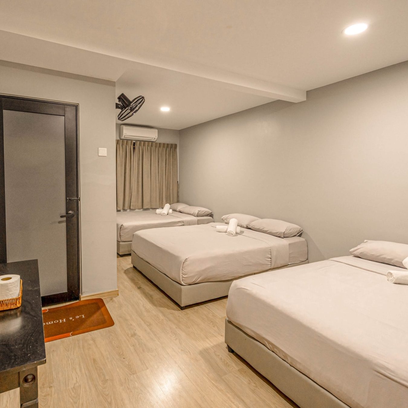 Spacious family bedroom layout with multiple queen beds at Le's Homestay
