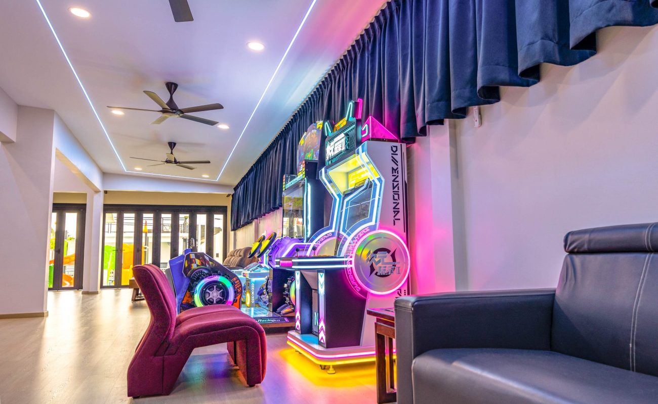 Neon lit racing arcade game machines entertainment zone at Le's Homestay A'Famosa Homestay villa