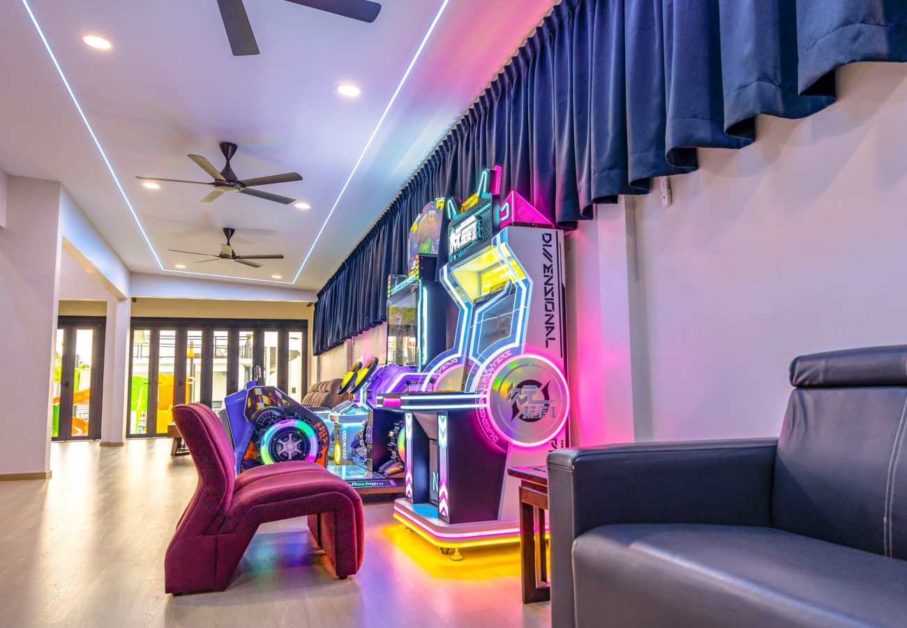Neon lit racing arcade game machines entertainment zone at Le's Homestay A'Famosa Homestay villa