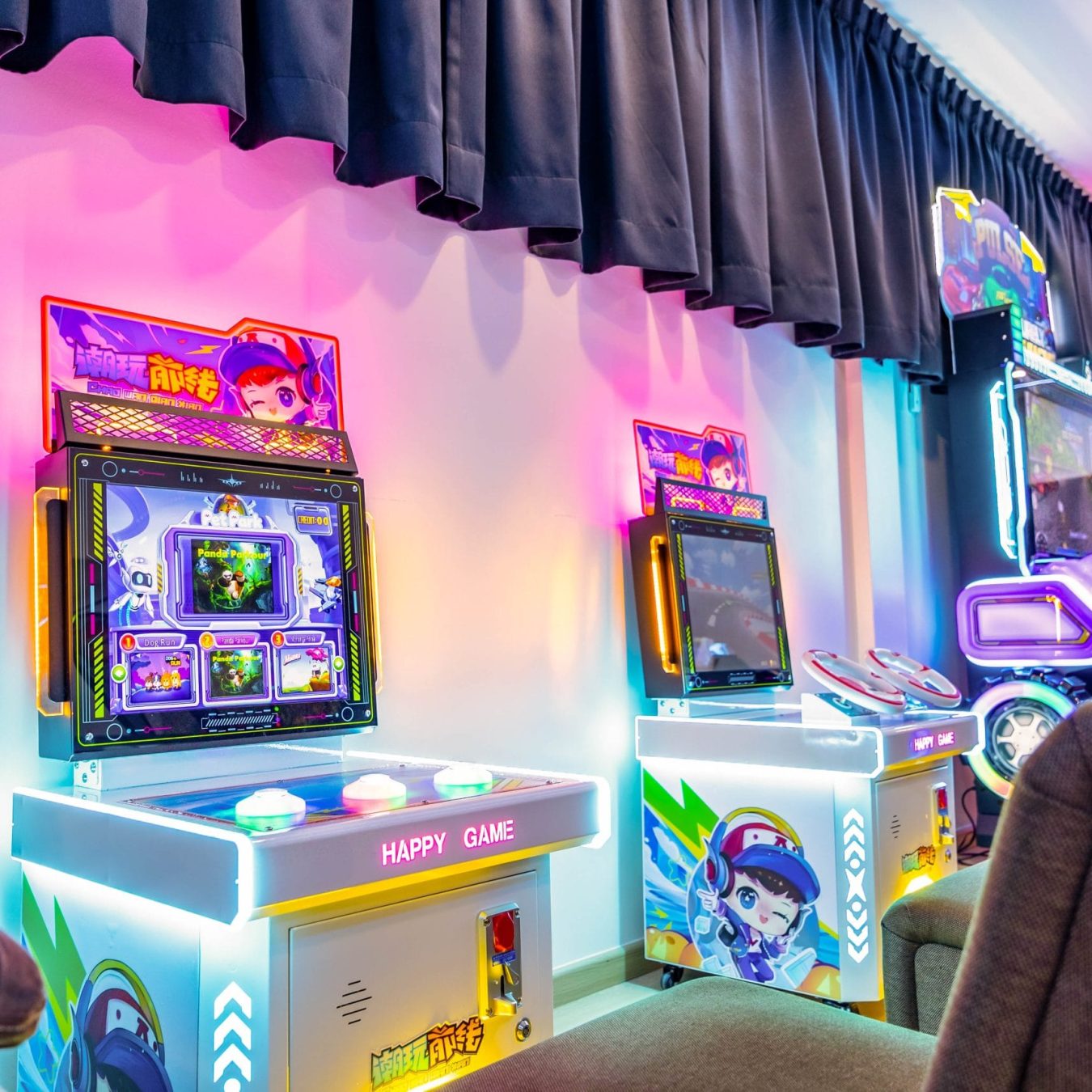Retro arcade game machines with neon lights at Le's Homestay game room