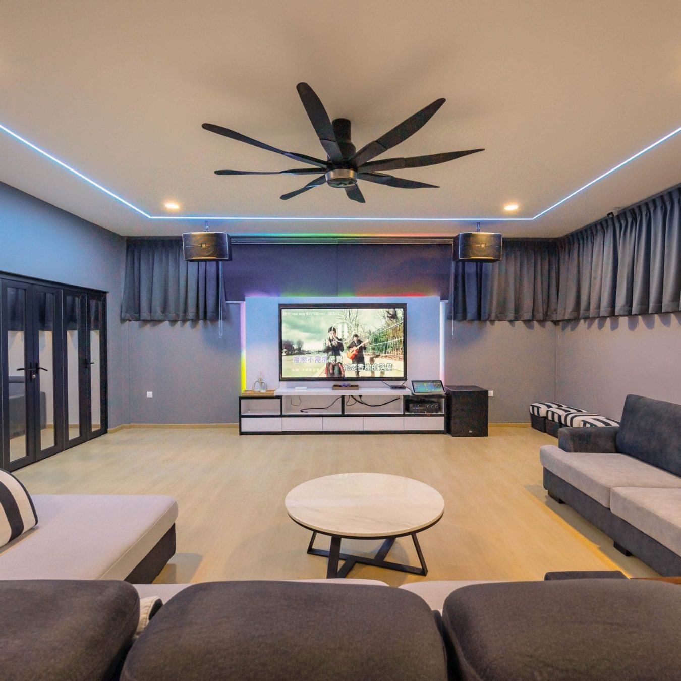 Spacious living room with karaoke system and large TV at Le's Homestay