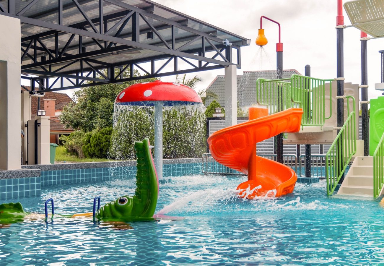 Kids mini water park pool with mushroom slide and crocodile float at Le's Homestay A'Famosa Homestay
