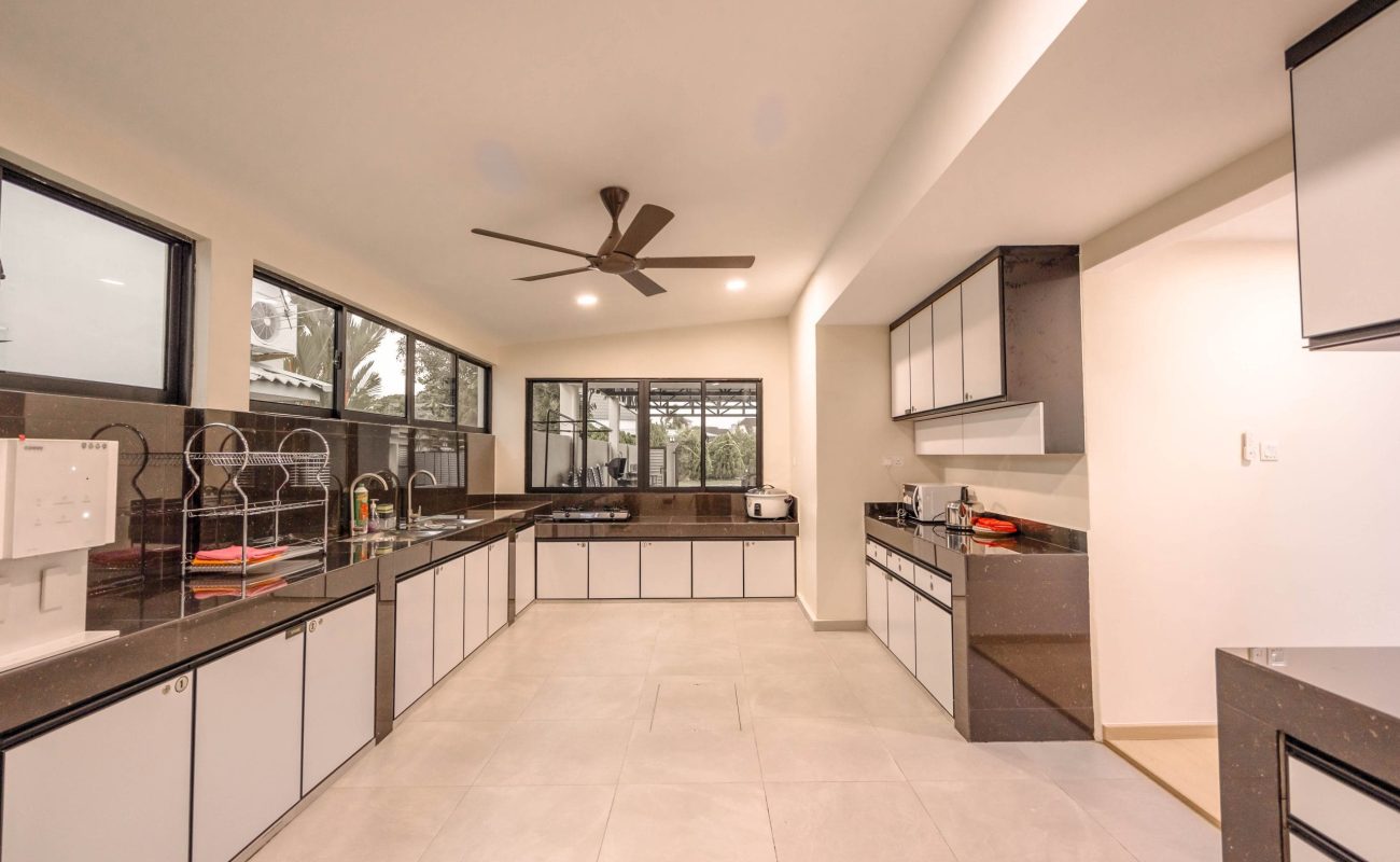 Spacious fully equipped modern kitchen area with cabinets at Le's Homestay A'Famosa Homestay