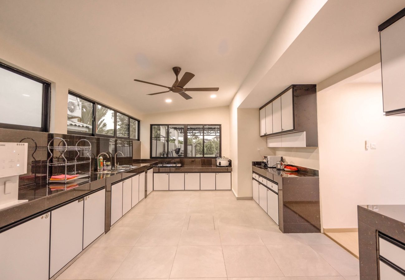 Spacious fully equipped modern kitchen area with cabinets at Le's Homestay A'Famosa Homestay