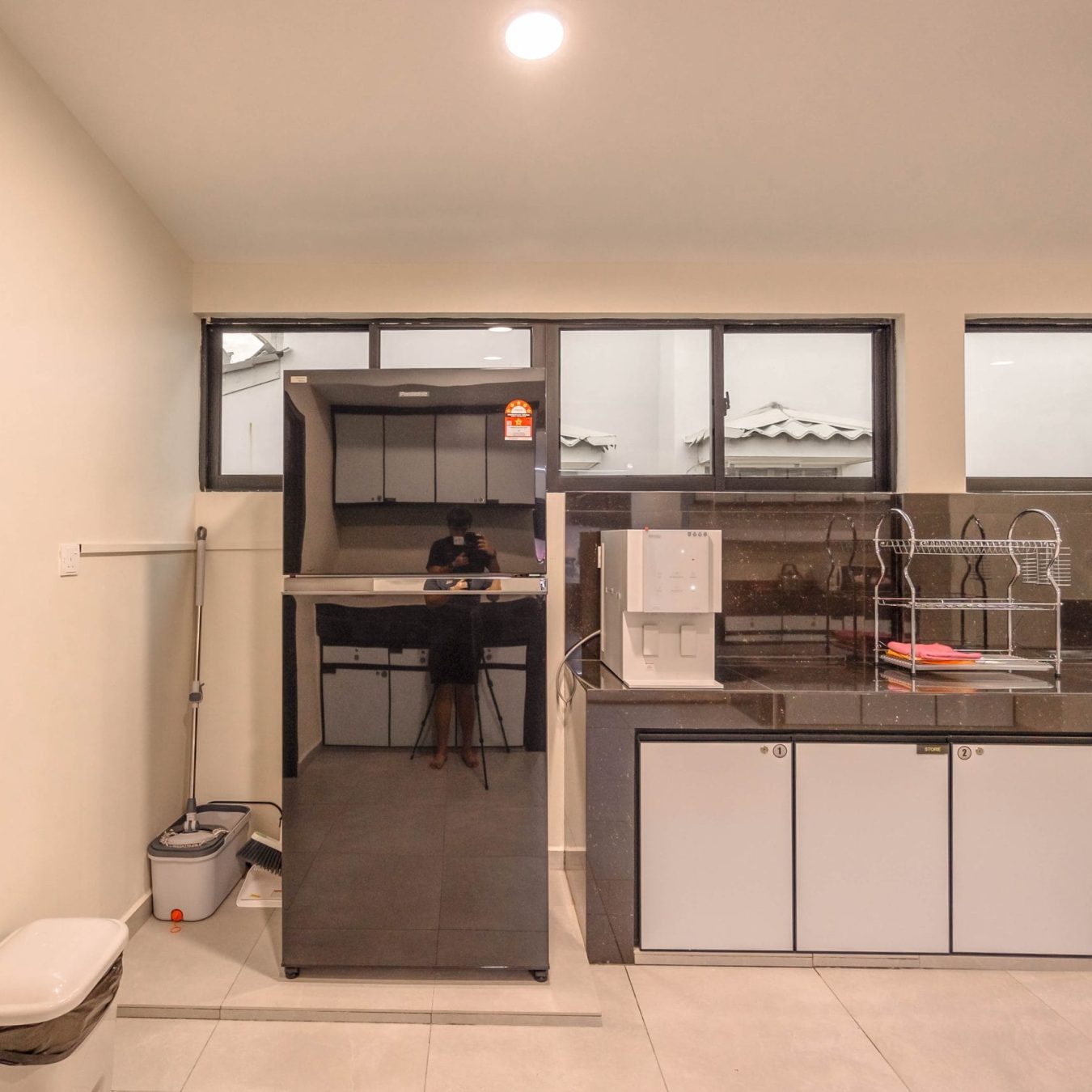 Fully equipped kitchen pantry with fridge and water dispenser at Le's Homestay Lot 914 A'Famosa Homestay