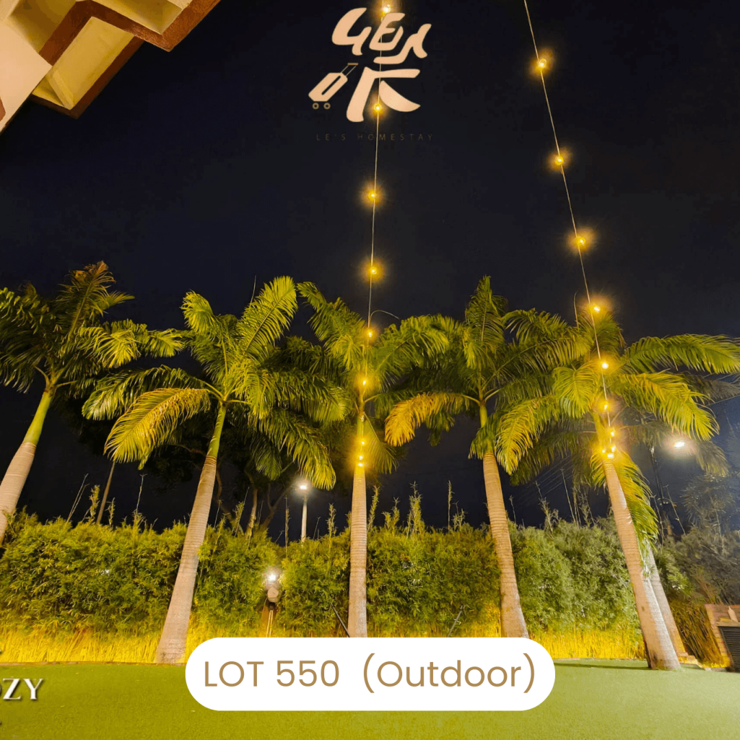 Decorated garden with palm trees and fairy lights at Le's Homestay Lot 550, a scenic Homestay Melaka Private Pool.