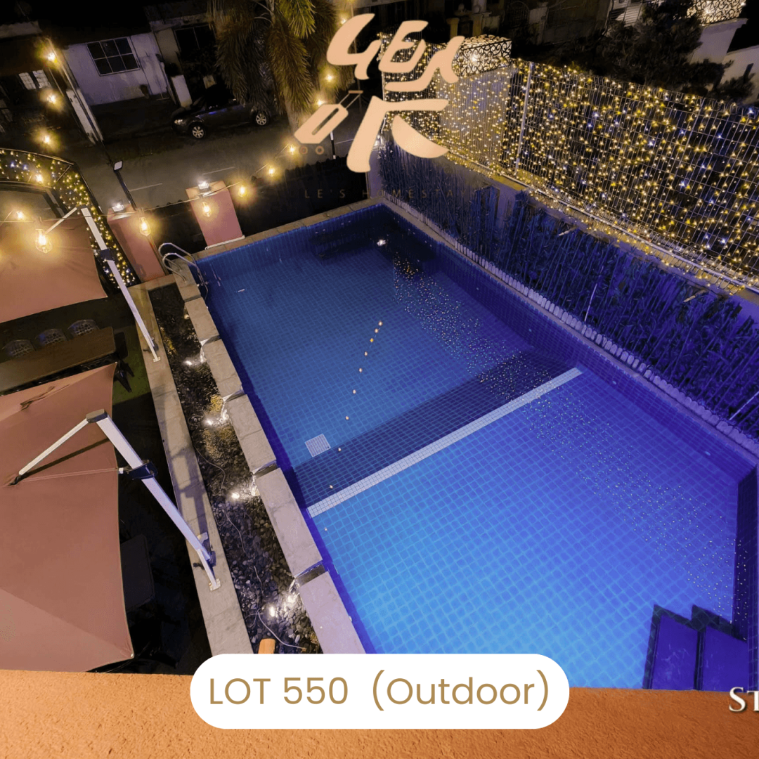 Aerial view of large private swimming pool at night at Le's Homestay Lot 550, a Homestay Melaka Private Pool villa.
