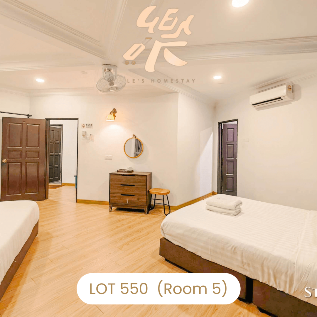 Large family room with multiple beds and wooden furniture at Le's Homestay Lot 550, a Homestay Melaka Private Pool villa (Room 5).