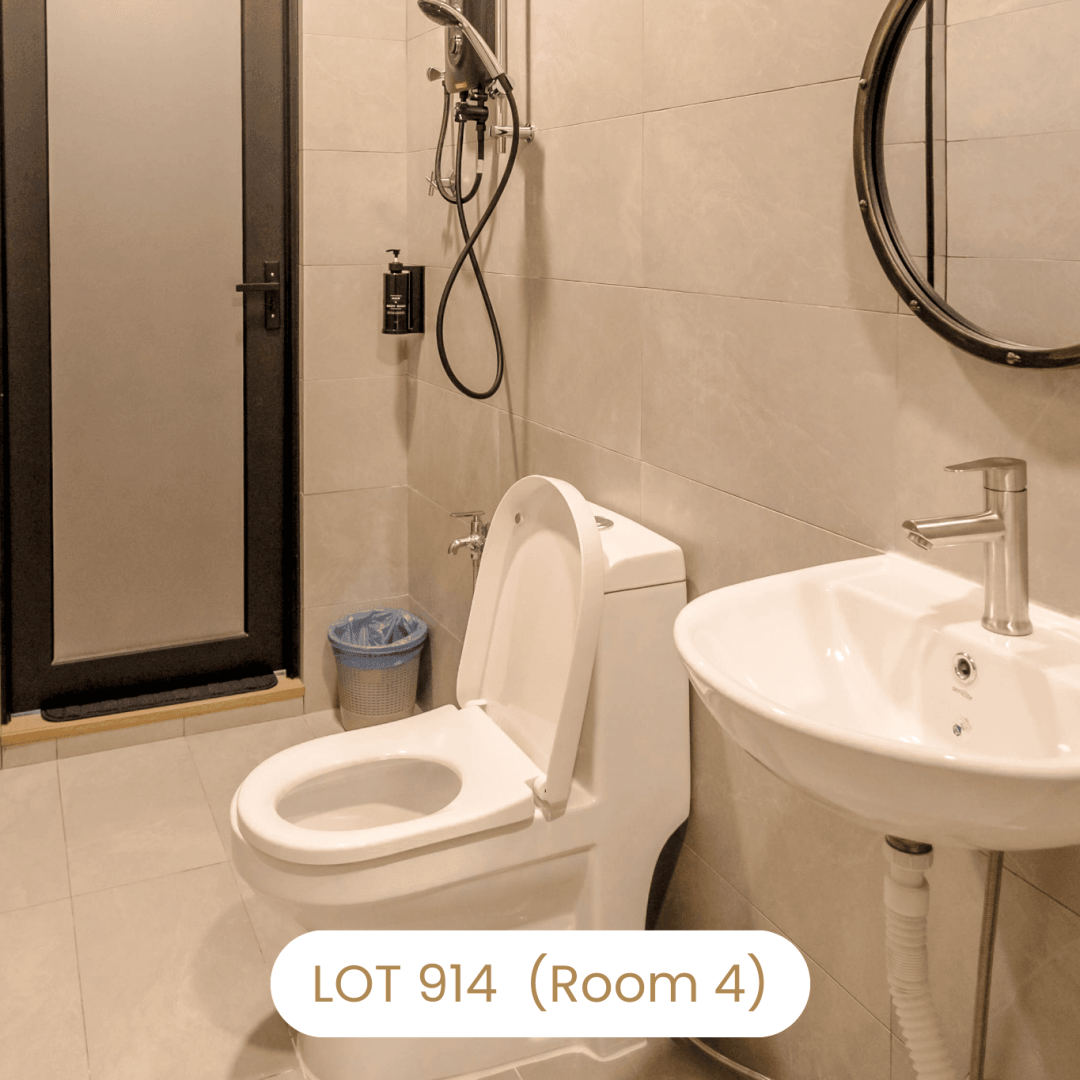 Clean ensuite bathroom with sink and toilet amenities at Le's Homestay Lot 914