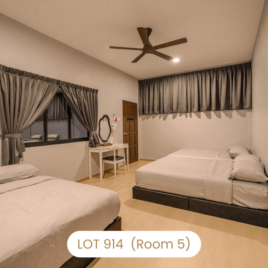 Comfortable bedroom setup with vanity table and multiple beds at Le's Homestay Lot 914 A'Famosa Homestay